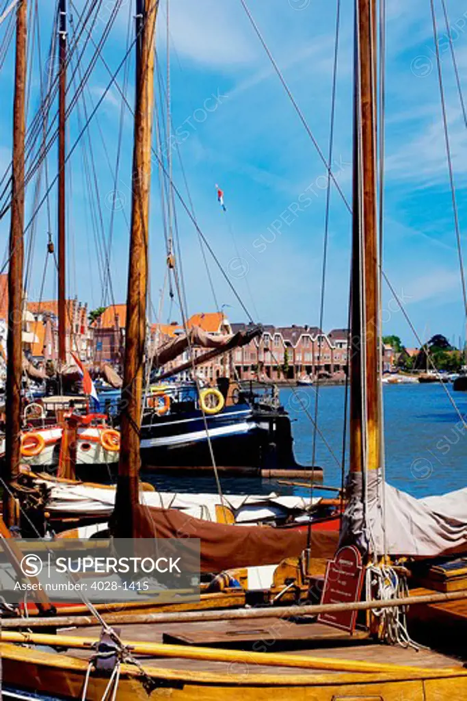 Netherlands, Hoorn, Old wooden sailboats moored along the banks.