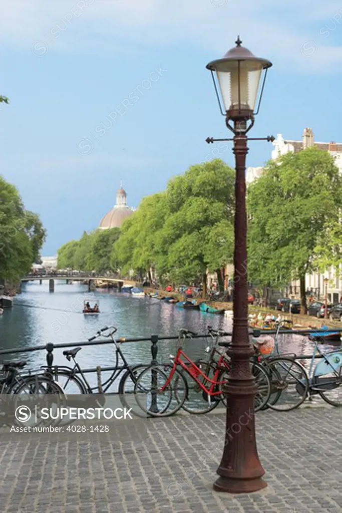 Amsterdam, Holland, Old gas lamp post and bicycles on a bridge over a canal in The Netherlands