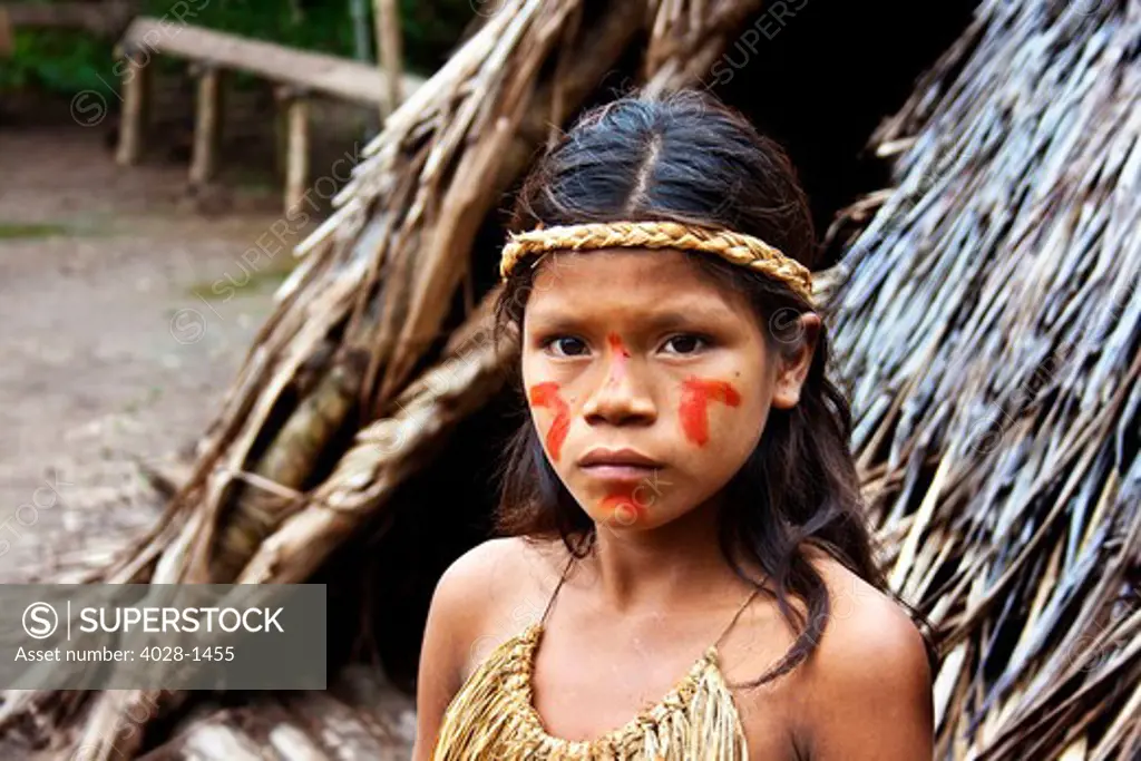 Young girl poses outside of her tribal village in the Peruvian Amazon Jungle near Iguitos, Peru.