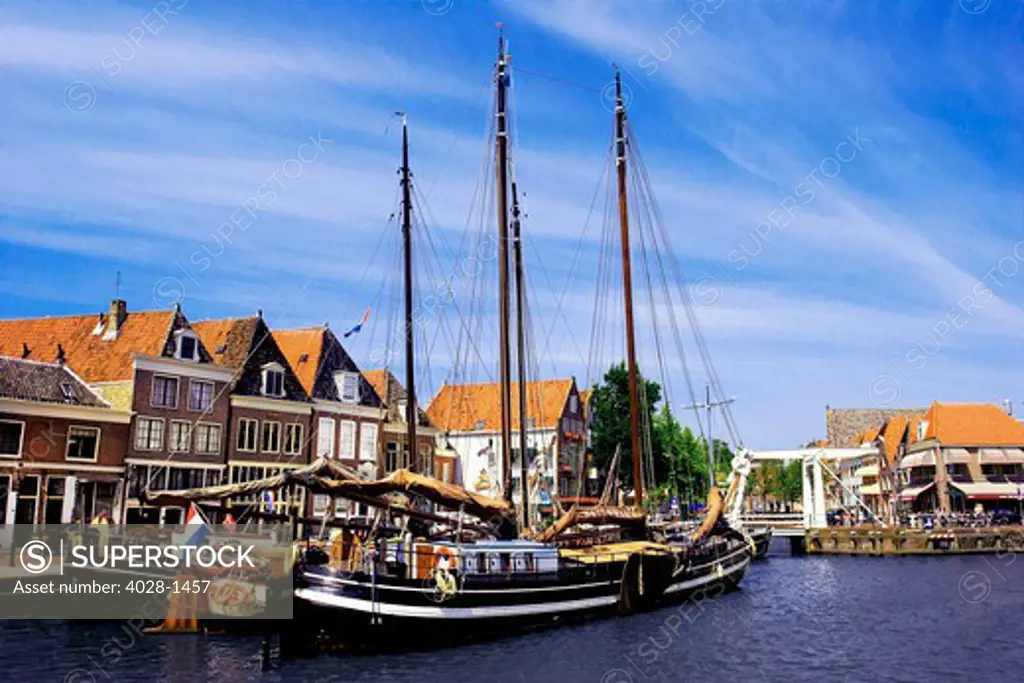 Netherlands, Hoorn, Old wooden sailboats moored along the banks.