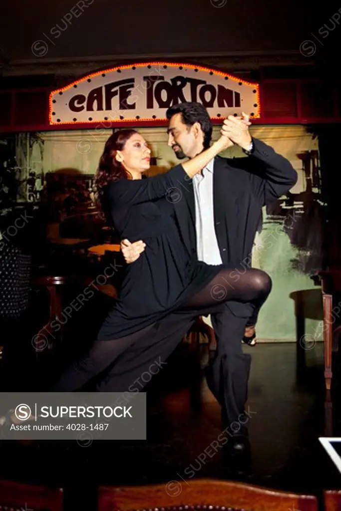 A couple dance the Tango at Cafe Tortoni, a famous tango cafe restaurant located on Avenue de Mayo, Buenos Aires, Argentina, South America