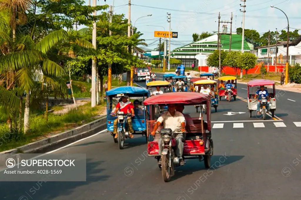 Iquitos, Peru, Motor bike taxis take villagers to their destinations down the main street