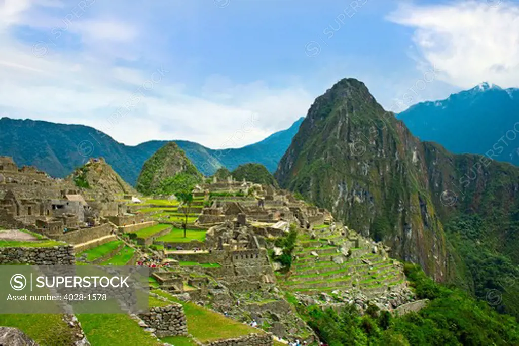 Tourists take in the awesome vista of ancient lost city of the Inca, Machu Picchu in the Sacred Valley of Peru, South America