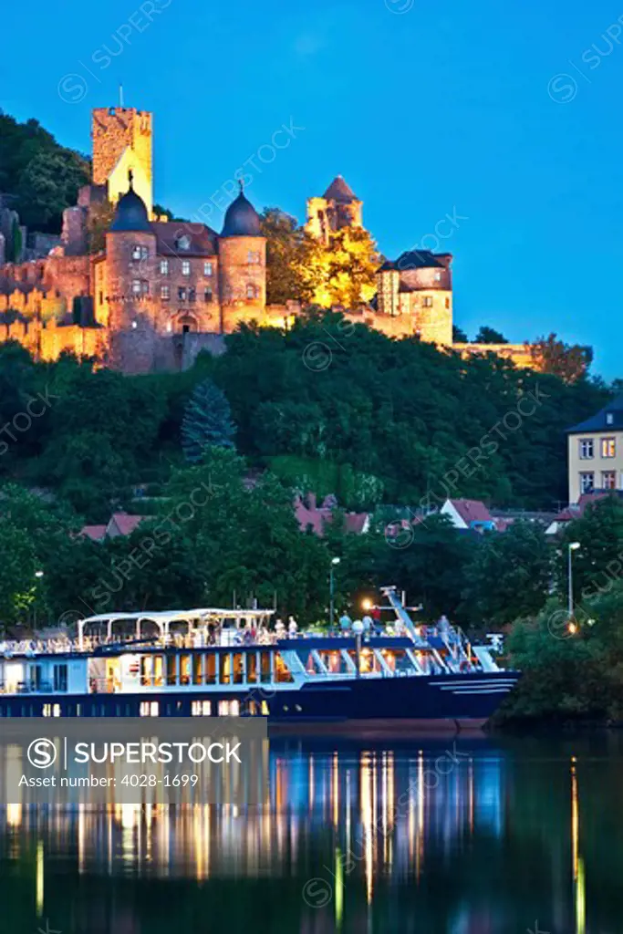 Wertheim, Franconia, Germany, A River cruise ship docked outside of with Wertheim Castle in the background at sunset