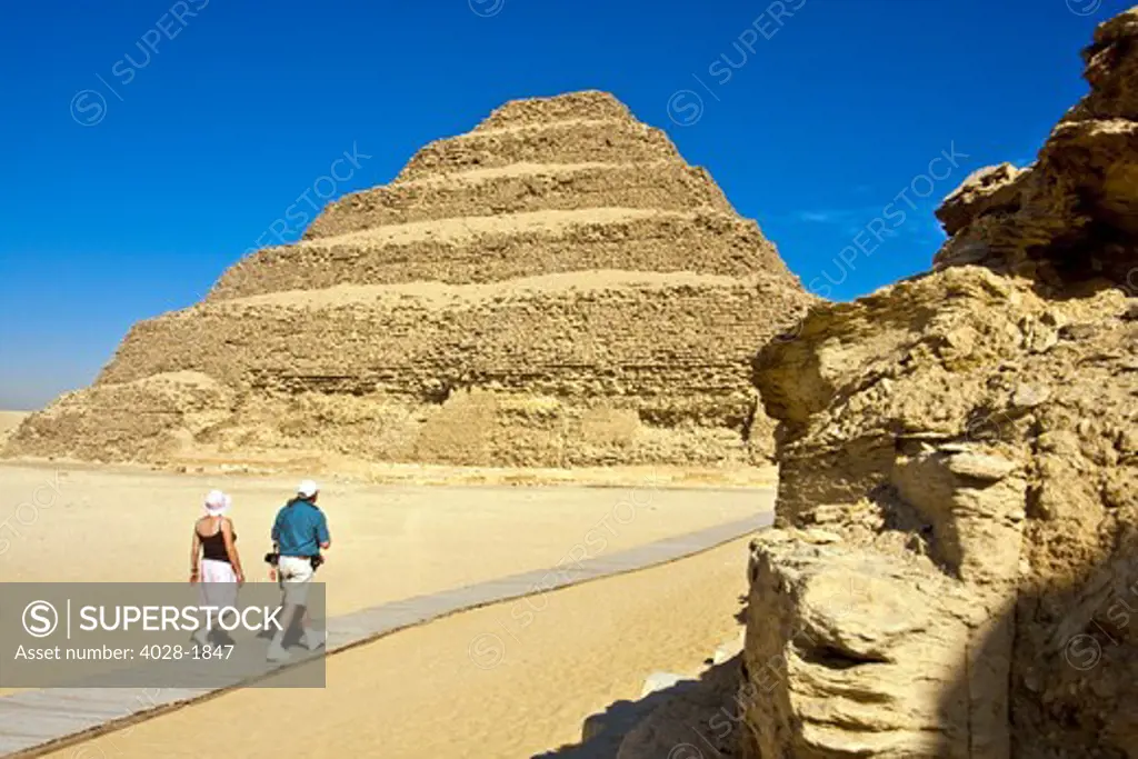Egypt, Saqqara, tourists walk to get a different view of Djoser's (Zoser) step pyramid.