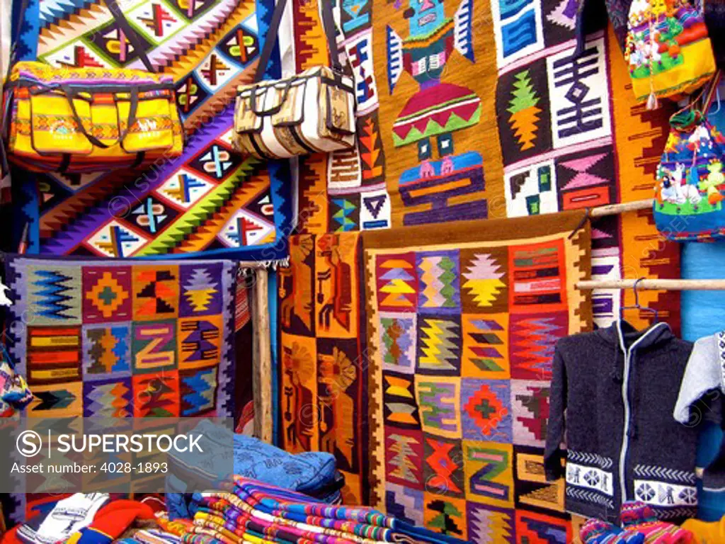 Colorful blankets, hats, sweaters and bags at indigenous market in Pisac, Peru in the Sacred Valley.