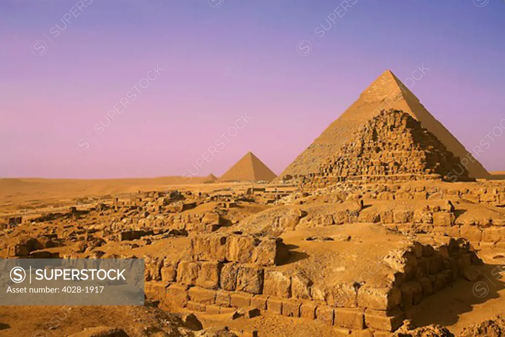 Egypt, Cairo, Giza, View of all three Great Pyramids with the lesser pyramids of their Queens in the foreground.