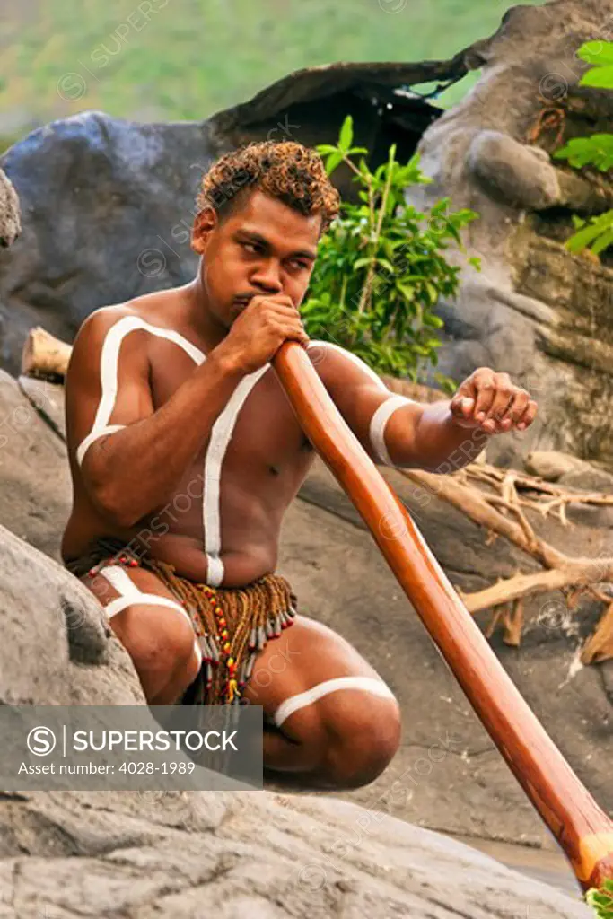 Cairns, Australia,  Aborigine man playing a didgeridoo