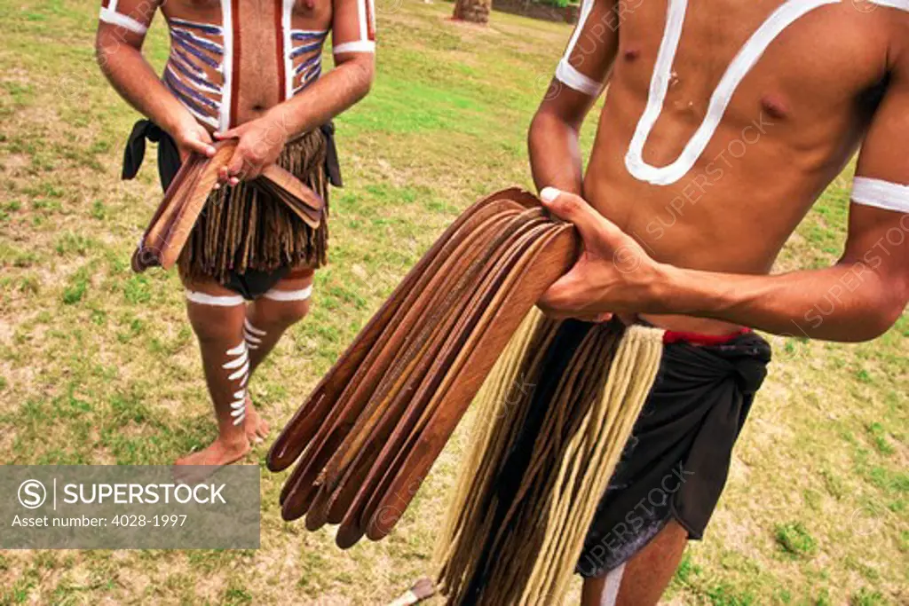 Cairns, Australia,  Aborigine men holding traditional weapons, boomerangs