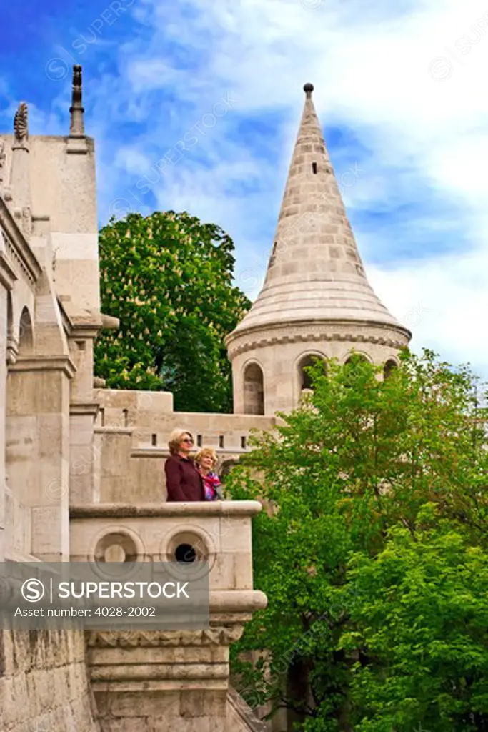 Two women lookout from Fisherman's Bastion on Castle Hill, Buda, Hungary, Budapest