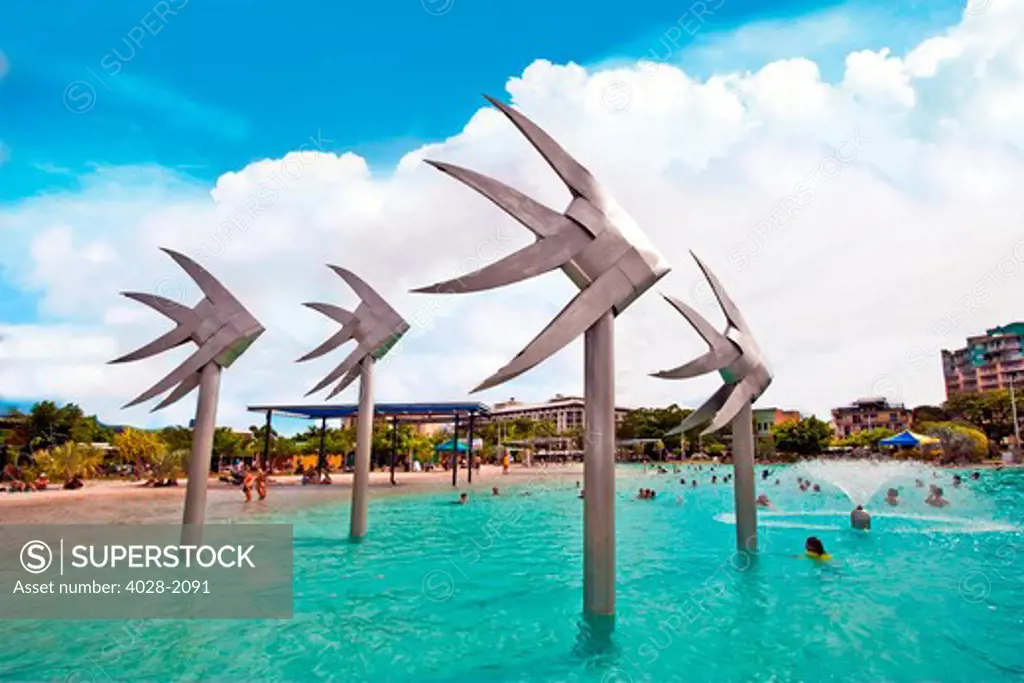 People swimming by the fish sculpture at Esplanade lagoon, Cairns, Queensland, Australia