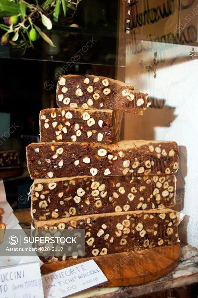 Panforte with figs and hazel nuts cakes in a bakery window in Florence, Tuscany, Italy, Europe