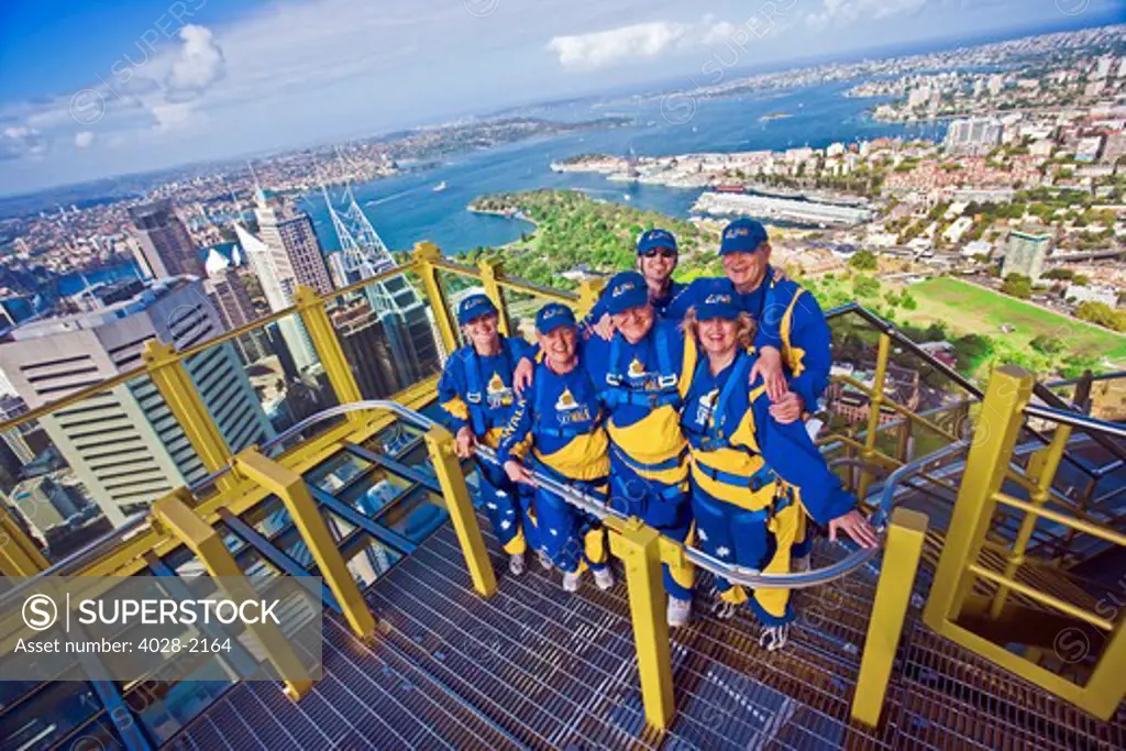 Australia, Sydney, New South Wales, tourists stand on a platform outside of the Sydney tower on the Skywalk