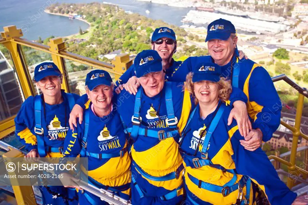 Australia, Sydney, New South Wales, tourists pose outside of the Sydney tower on the Skywalk