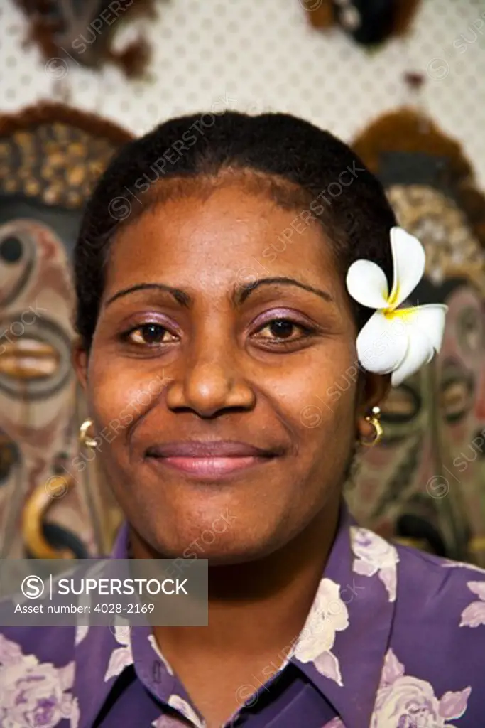 Fiji, Portrait of a smiling Fijian woman with a flowerin her hair