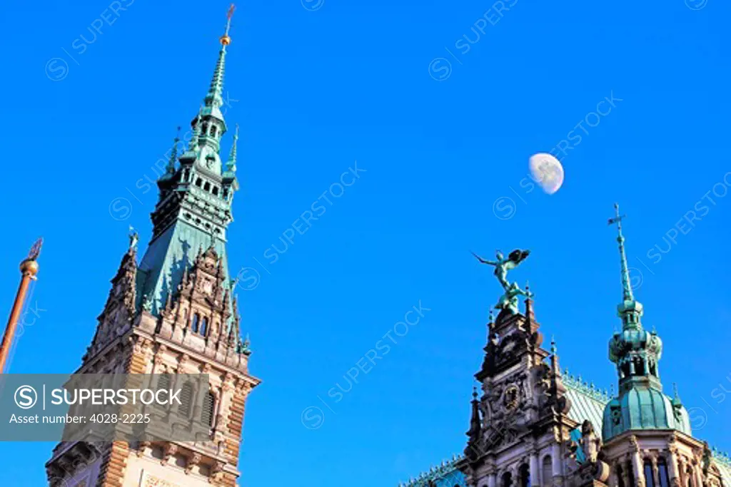 A blue sky moon highlights a Sculpture of St. Michael, on Hamburg City Hall in Rathausmarkt square, Hamburg, Germany