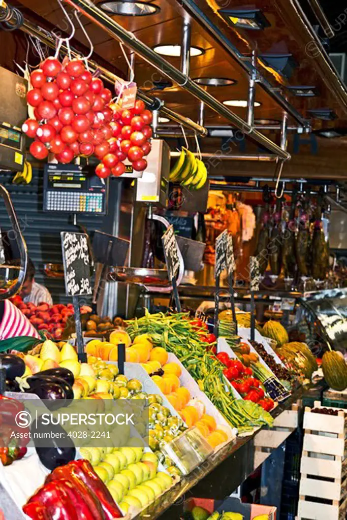 Barcelona, Catalonia, Spain, Mercat De La Boqueria, La Rambla, vendors display and sell fruits and vegetables in their stall .