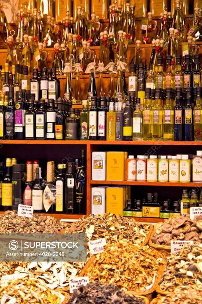 Barcelona, Catalonia, Spain, La Boqueria, La Rambla, vendors display and sell mushrooms, truffles and oils in their market stall.