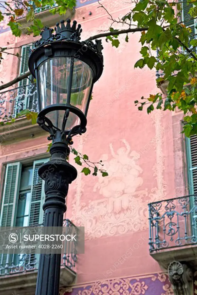 Barcelona, Catalonia, Spain, Ornate street lamp and balcony creating the atmosphere of the Gothic Quarter.
