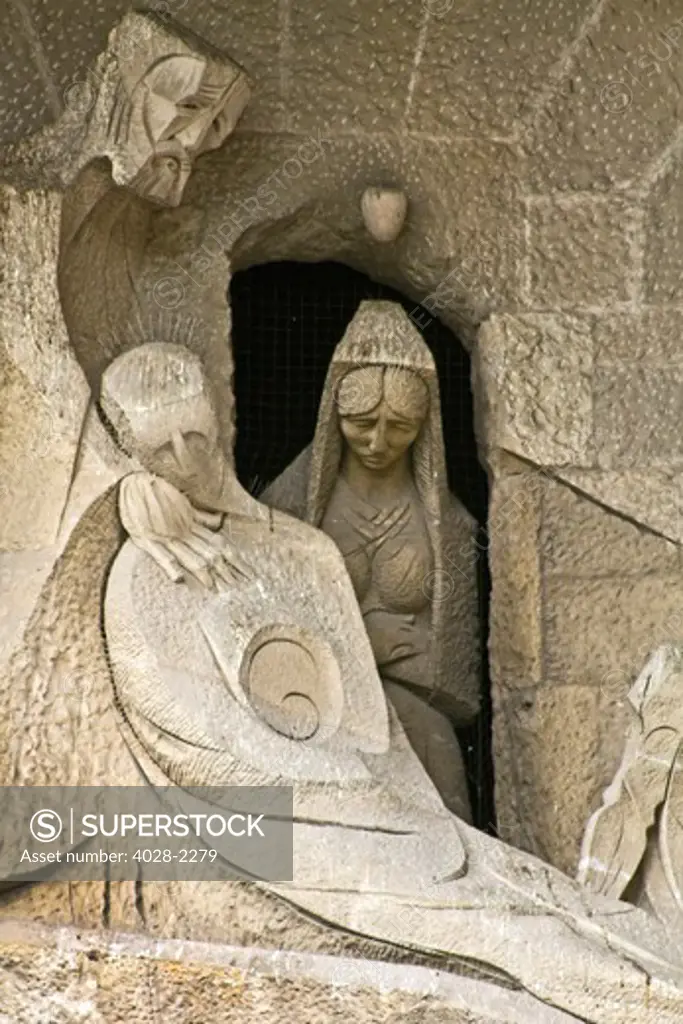 Barcelona, Catalonia, Spain, statues and stonework of  the Passion Facade of  the Temple of Sagrada Familia, by architect Josep Maria Subirachs. Death and burial of Jesus witnessed by Mary and Joseph