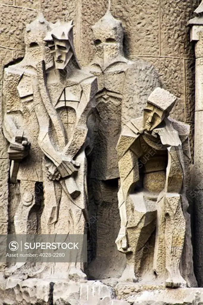 Barcelona, Catalonia, Spain, statues and stonework of  the Passion Facade of  the Temple of Sagrada Familia, by architect Josep Maria Subirachs. The judgement of Jesus as Roman guards watch.