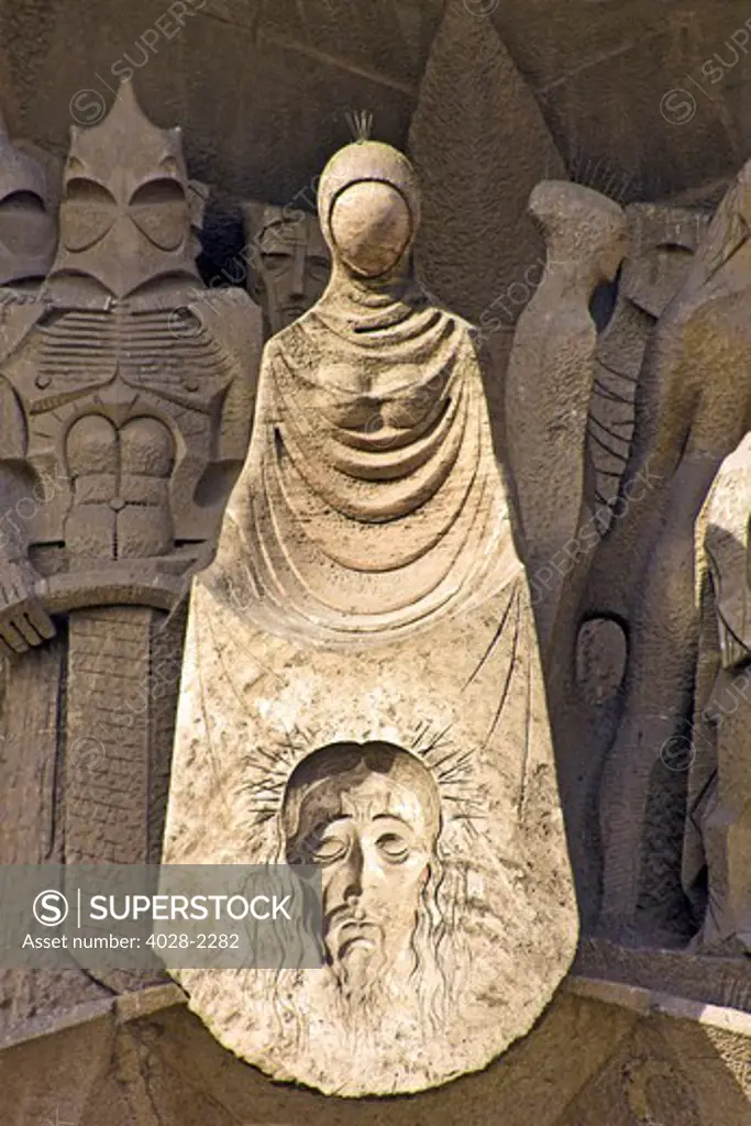 Barcelona, Catalonia, Spain, statues and stonework of  the Passion Facade of  the Temple of Sagrada Familia, by architect Josep Maria Subirachs.  The calvery of Jesus with his image on Mary's dress.