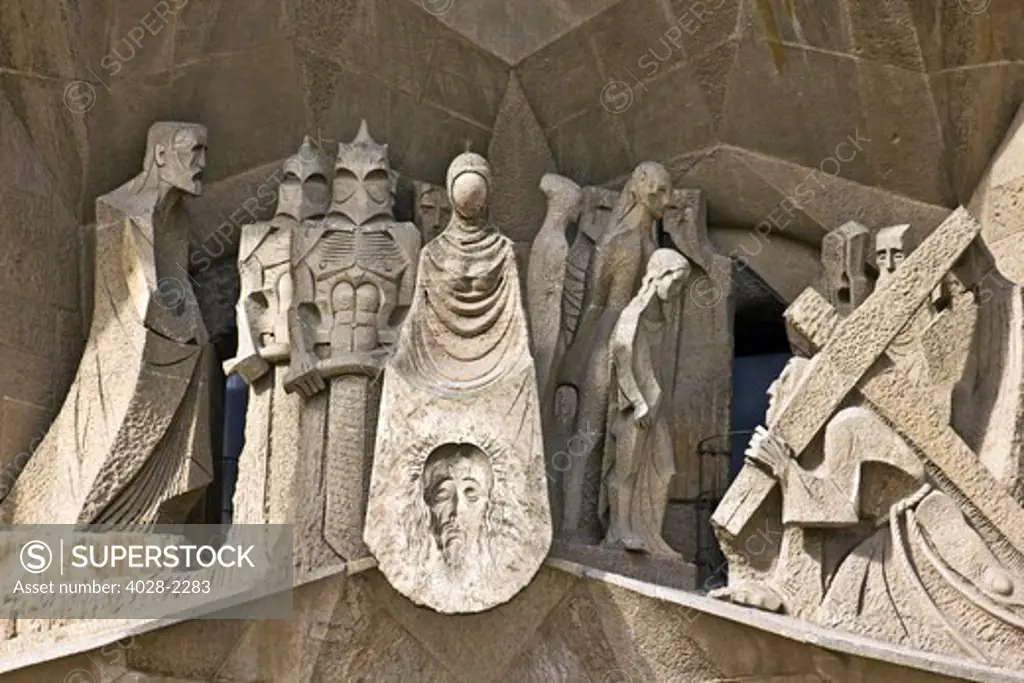 Barcelona, Catalonia, Spain, statues and stonework of  the Passion Facade of  the Temple of Sagrada Familia, by architect Josep Maria Subirachs.  The calvery of Jesus carrying the cross.