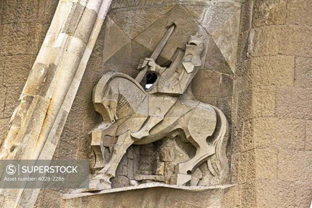 Barcelona, Catalonia, Spain, statues and stonework of  the Passion Facade of  the Temple of Sagrada Familia, by architect Josep Maria Subirachs. Longinus, the soldier who put his lance in Christ's side.