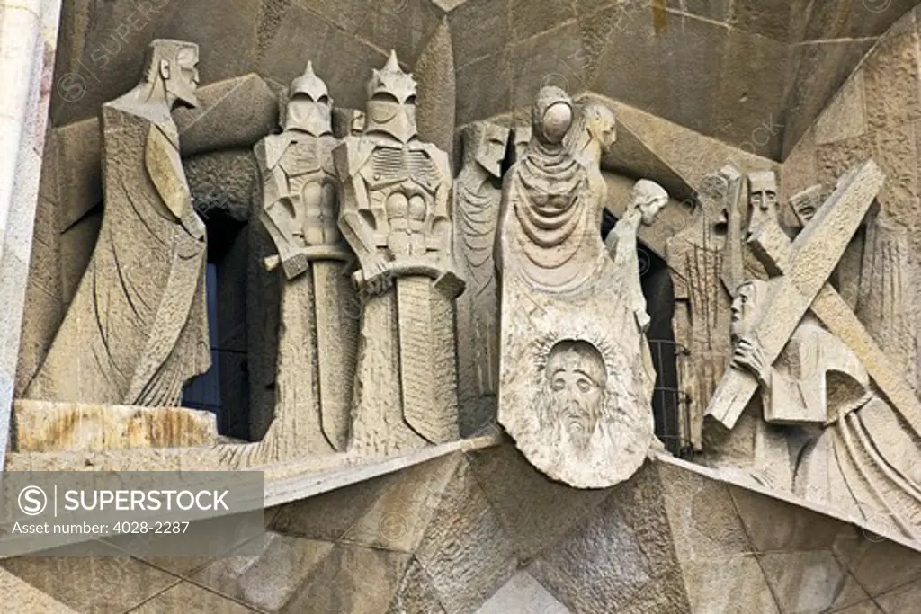 Barcelona, Catalonia, Spain, statues and stonework of  the Passion Facade of  the Temple of Sagrada Familia, by architect Josep Maria Subirachs.  The calvery of Jesus carrying the cross.