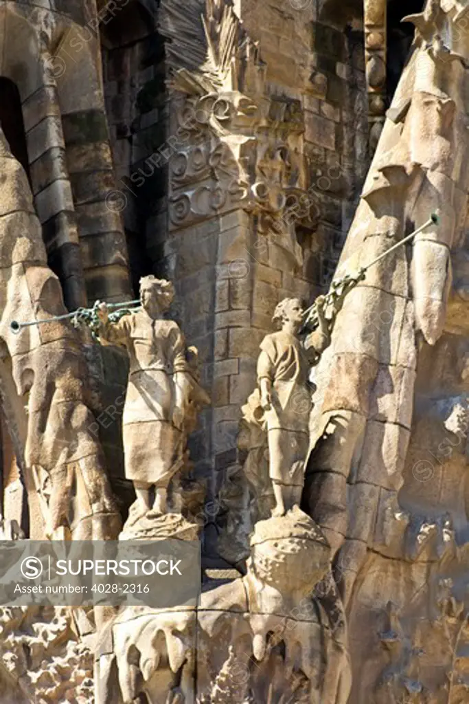 Spain, Catalonia, Barcelona, Sagrada Familia, statues and stonework of  the Nativity facade (Gaudi architect). Trumpeters herald the marriage of Mary and Joseph.