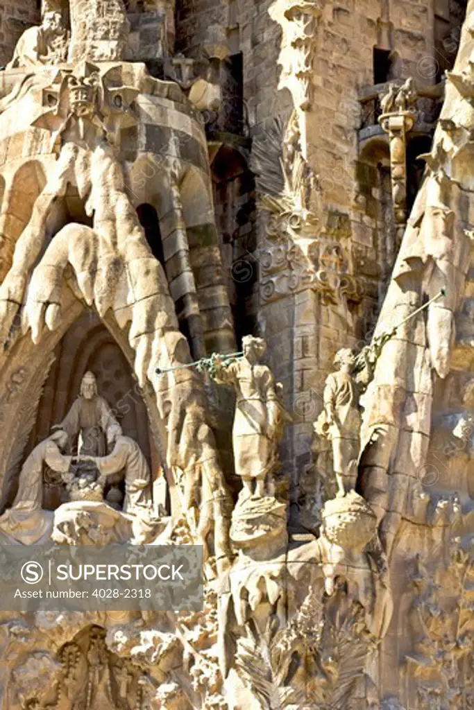 Spain, Catalonia, Barcelona, Sagrada Familia, statues and stonework of  theNativity facade (Gaudi architect). Trumpeters herald the marriage of Mary and Joseph.