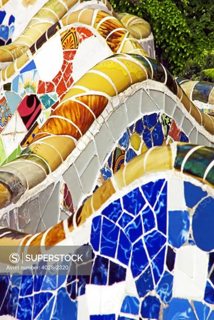 Barcelona, Catalonia, Spain, Detail of  the multi-coloured tiled mosaic bench in Guell Park by Antonio Gaudi.