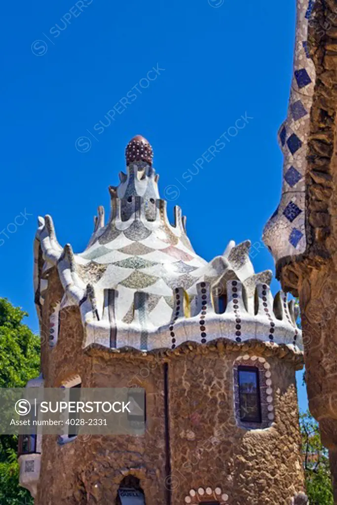 Barcelona, Catalonia, Spain, Detail of  a multi-coloured tiled mosaic Fanciful Houses in Guell Park by Antonio Gaudi.