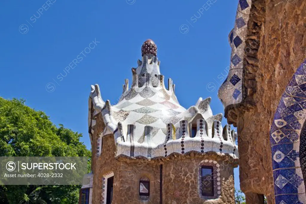 Barcelona, Catalonia, Spain, Detail of  a multi-coloured tiled mosaic fanciful Houses in Guell Park by Antonio Gaudi.