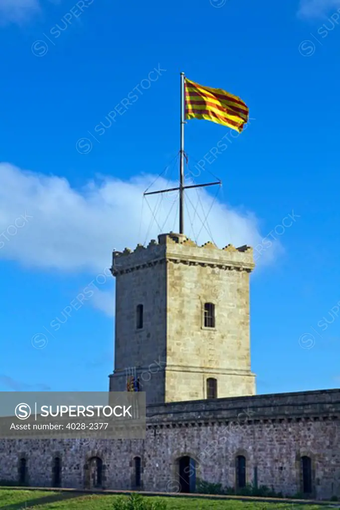 Barcelona, Catalonia, Spain, the Catalonian flag waves over Montjuic Castle on Montjuic Hill