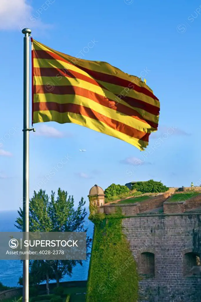 Barcelona, Catalonia, Spain, the Catalonian flag waves over Montjuic Castle on Montjuic Hill