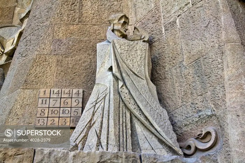 Barcelona, Catalonia, Spain, statues and stonework of  the Passion Facade of  the Temple of Sagrada Familia, by architect Josep Maria Subirachs. The betrayal of Judas and the Magic Square counting to the age of Jesus' death of 33.
