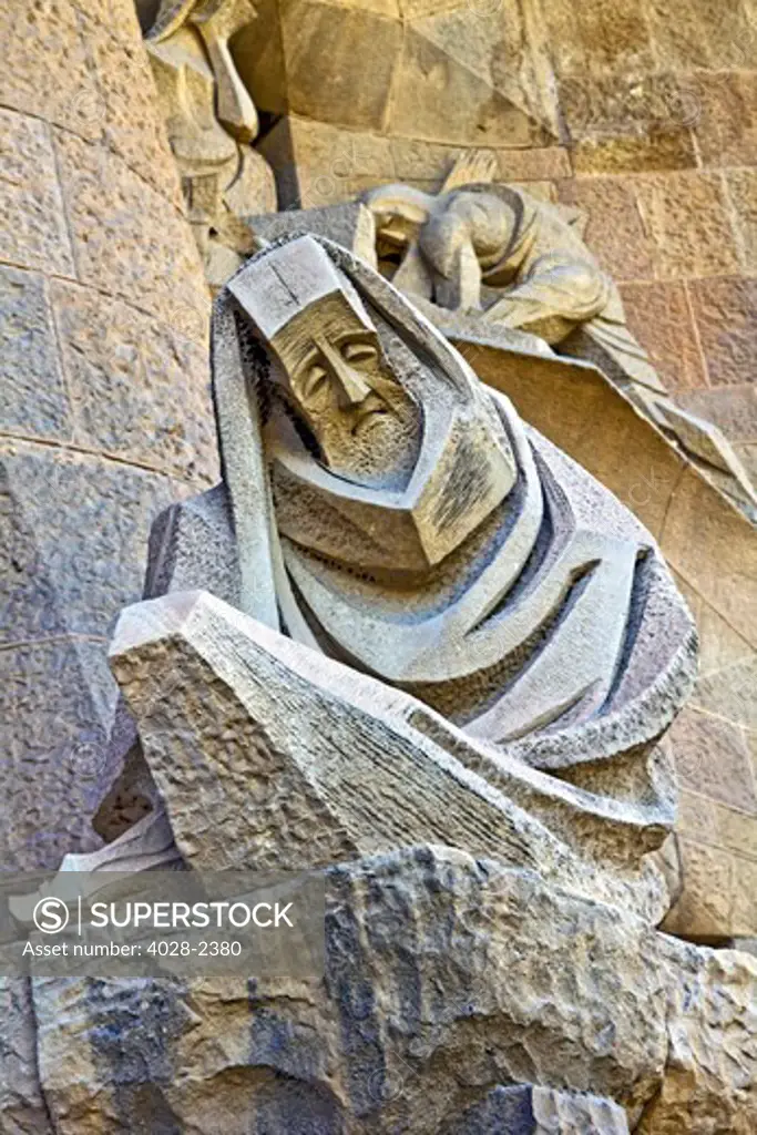 Barcelona, Catalonia, Spain, statues and stonework of  the Passion Facade of  the Temple of Sagrada Familia, by architect Josep Maria Subirachs. The Apostle Peter's Denial.