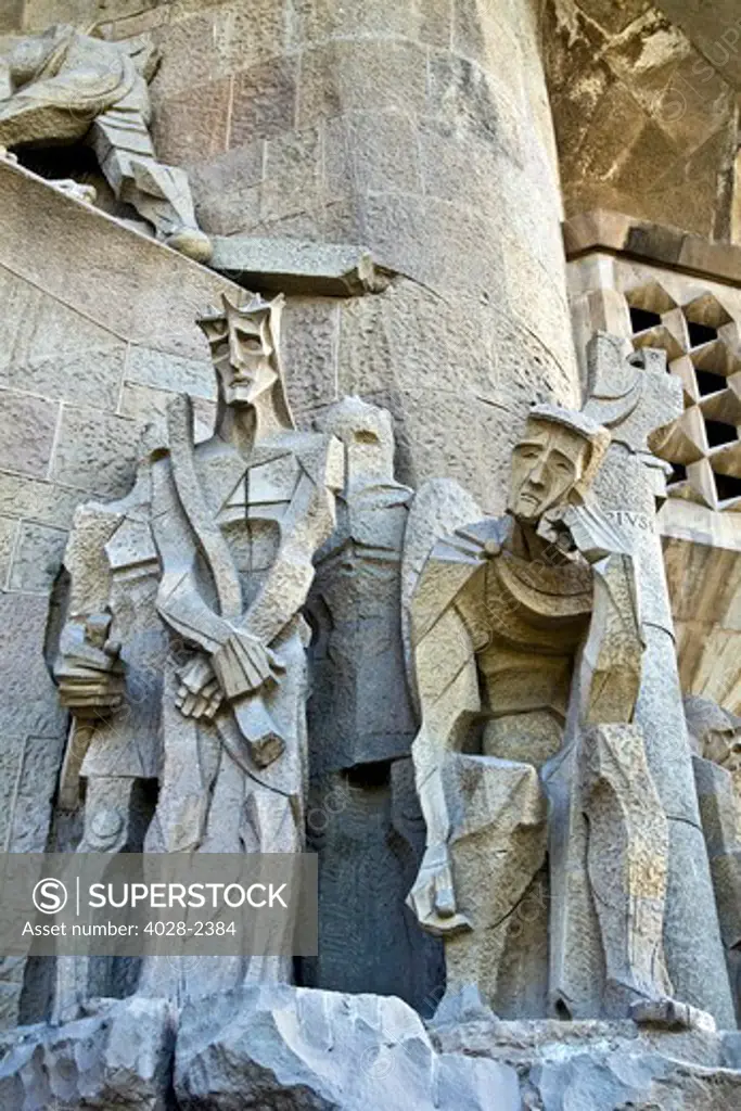 Barcelona, Catalonia, Spain, statues and stonework of  the Passion Facade of  the Temple of Sagrada Familia, by architect Josep Maria Subirachs. The judgement of Jesus as Roman guards watch.