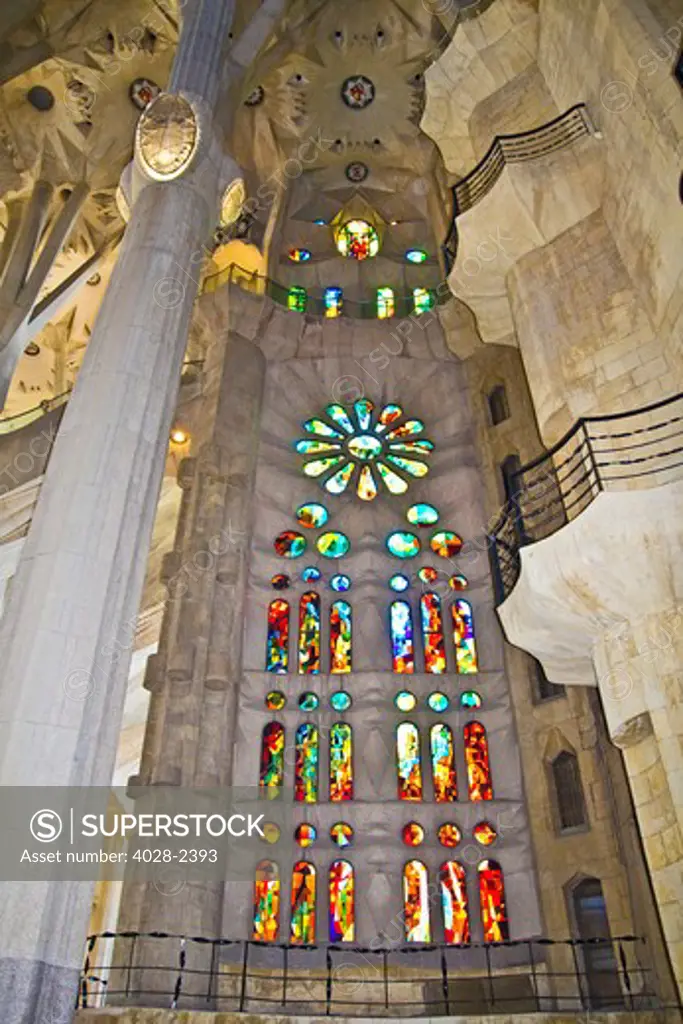 Barcelona, Catalonia, Spain, ornate stained glass window, column and ceiling of the Interior of Sagrada Familia