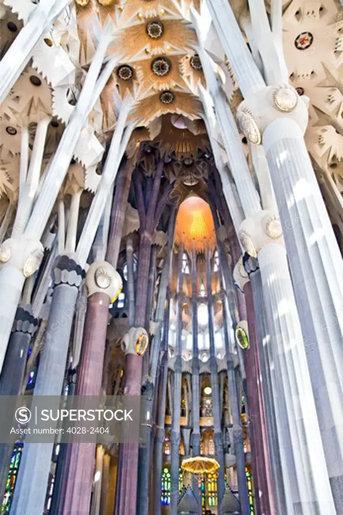 Barcelona, Catalonia, Spain, ornate alter, stained glass window, column and ceiling of the Interior of Sagrada Familia
