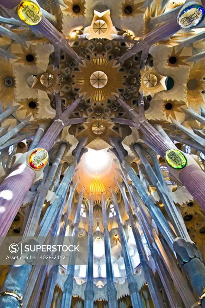 Barcelona, Catalonia, Spain, ornate stained glass window, column and ceiling of the Interior of Sagrada Familia