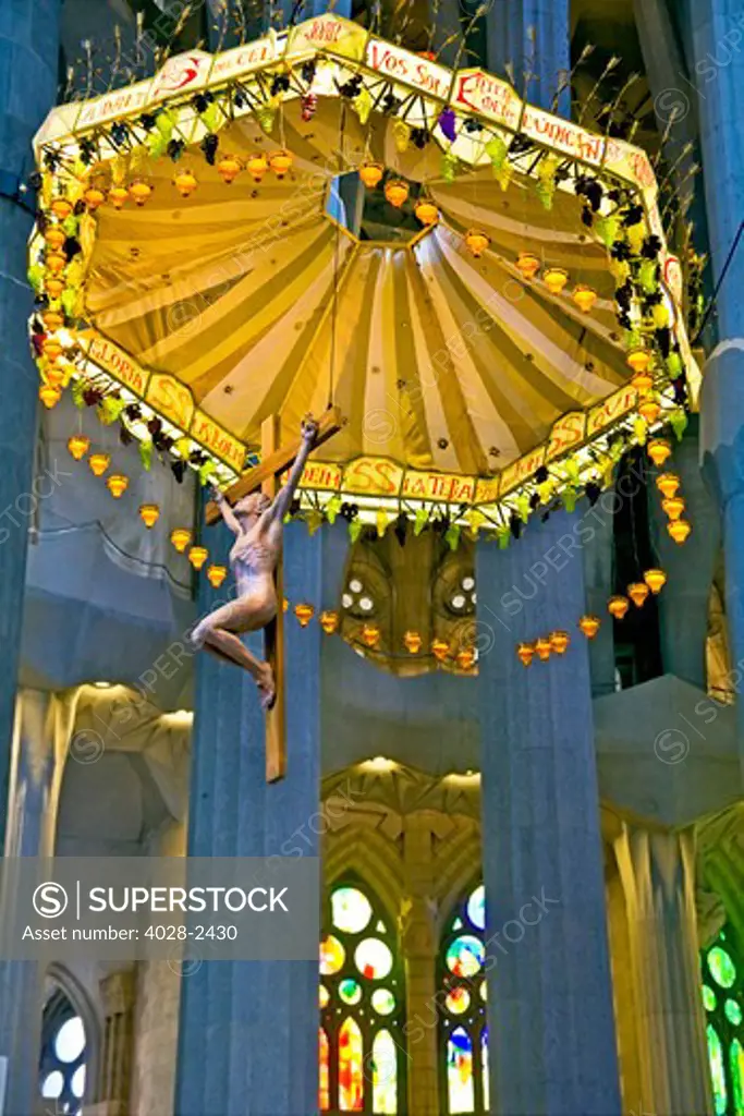 Barcelona, Catalonia, Spain, ornate alter, stained glass window, columns and ceiling of the Interior of Sagrada Familia