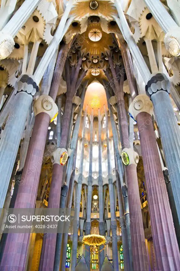 Barcelona, Catalonia, Spain, ornate vault, alter, stained glass window, columns and ceiling of the Interior of Sagrada Familia