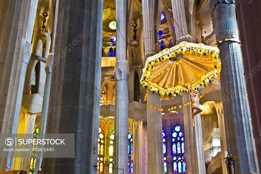 Barcelona, Catalonia, Spain, ornate alter, stained glass window, columns and ceiling of the Interior of Sagrada Familia