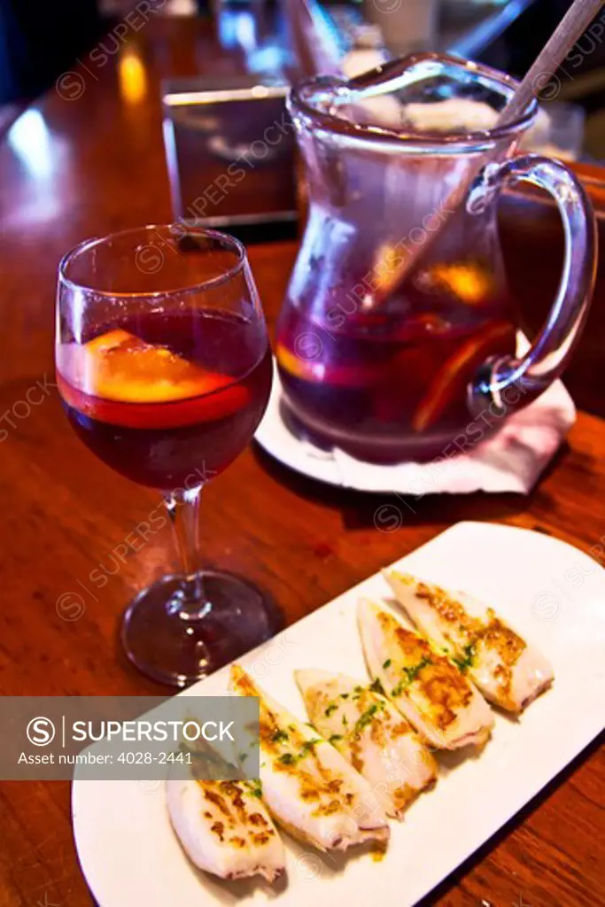 Barcelona, Catalonia, Spain, grilled calamari and a glass of sangria at a local Tapas bar