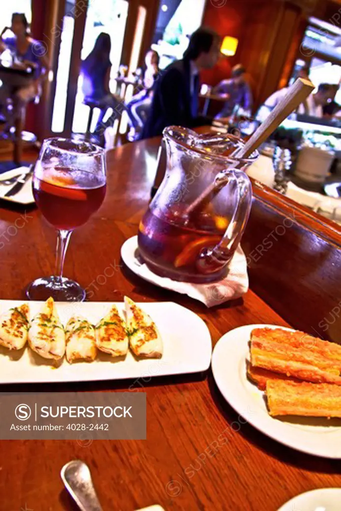 Barcelona, Catalonia, Spain, grilled calamari and a glass of sangria at a local Tapas bar