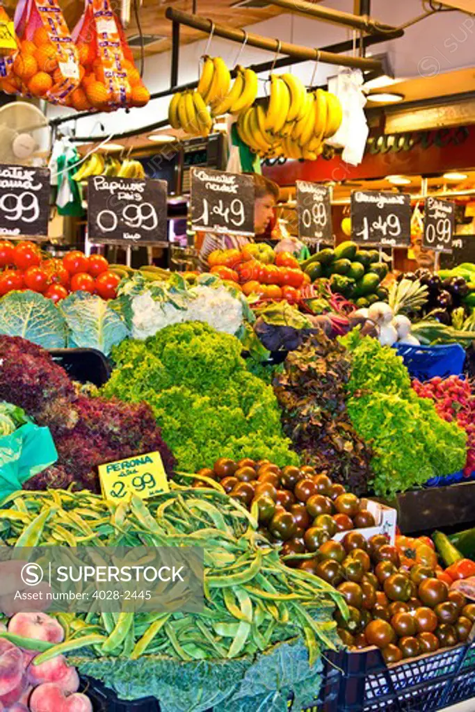 Barcelona, Catalonia, Spain, La Boqueria, La Rambla, vendors display and sell fruits and vegetables in their stall.