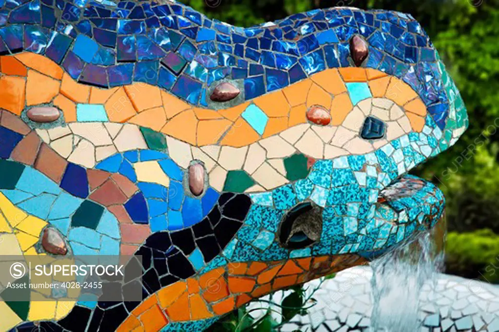 Barcelona, Catalonia, Spain, Detail of  the multi-coloured tiled mosaic lizard fountain in Guell Park by Antonio Gaudi.