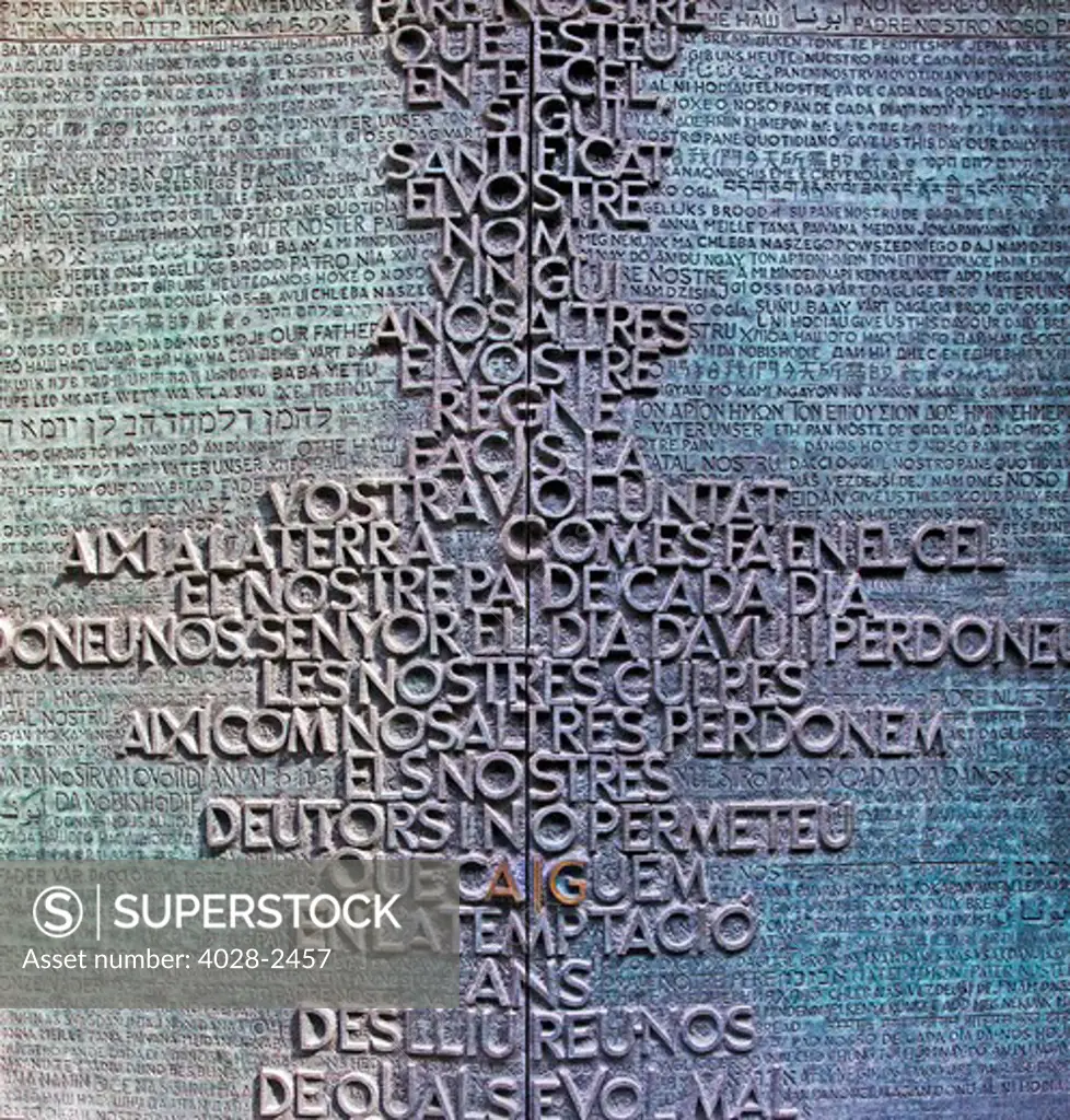 Barcelona, Catalonia, Spain, the entrance portico to the Glory Facade of  the Temple of Sagrada Familia, by architect Josep Maria Subirachs. The Eucarist written in 150 languages.